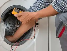 Washing machine repair technician testing a front-load washer with diagnostic tools in San Diego, CA